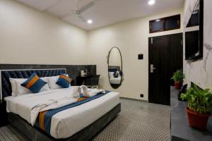 a bedroom with a large bed and a mirror at DIAMOND HOTEL in Mumbai