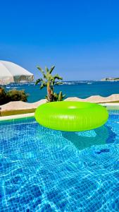 a green inflatable raft in a swimming pool at Villa Incanto on the Sea in Syracuse +57 photos