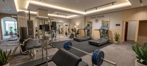a gym with treadmills and machines in a room at Le Vendome Hotel in Amman