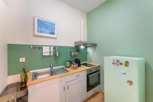 a small kitchen with a sink and a refrigerator at Folitsa happy central home in Rhodes Town