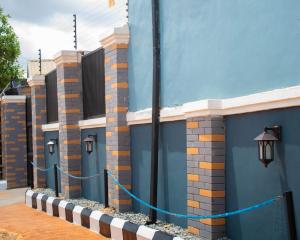 a blue building with lights on the side of it at Isuki apartment in Benin City