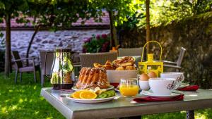 a table with a breakfast of bread and eggs and oranges at L'Abbaye d'Alspach in Kientzheim