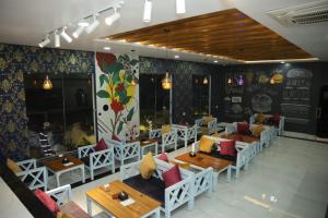 a restaurant with tables and chairs in a room at Shahi Land Hotel Pvt Ltd in Butwāl