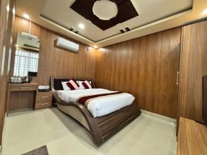 a bedroom with a bed in a wooden wall at Shahi Land Hotel Pvt Ltd in Butwāl