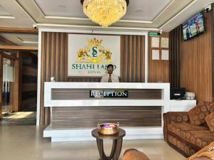 a man standing behind a podium in a lobby at Shahi Land Hotel Pvt Ltd in Butwāl