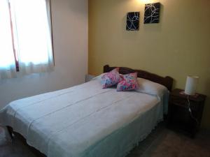 En eller flere senge i et værelse på Complejo Playa Grande