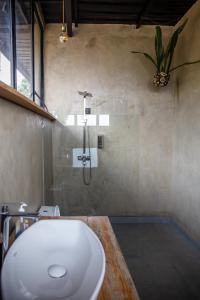 a bathroom with a white sink and a shower at Eagle View Lodge - Kigali in Kigali +100 photos