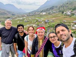 a group of people standing in front of a field at Peaceful Happiness Bungalow with Valley Views in Sapa