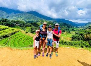 a group of people standing on top of a mountain at Peaceful Happiness Bungalow with Valley Views in Sapa