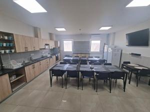 a large kitchen with a table and chairs in it at Hotel Venatus in Zalaegerszeg