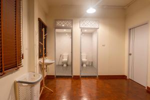 a bathroom with two toilets in a room at Baan Batra Heritage Suite in Bangkok +103 photos