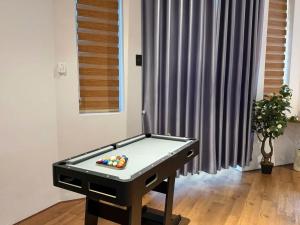 a ping pong table with balls on it in a room at Choco village 126A in Xã Thang Tam +21 photos