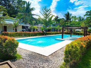 a swimming pool in a yard with a gazebo at Severina Lodge in San Juan