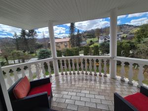 a balcony with a view of a house at Willa Helena in Cisna