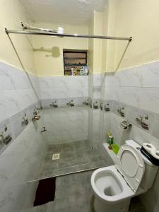 a white bathroom with a toilet and a shower at The perfect Hideout in Nairobi +7 photos