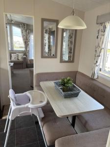 a living room with a table and a couch at Beach Retreats, Romney Sands, Parkdean Resorts in Greatstone