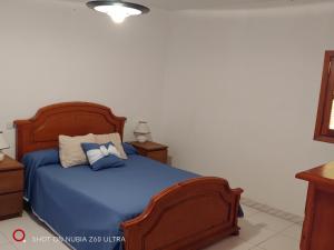 a bedroom with a blue bed with two night stands at casa el nacimiento in Igualeja +16 photos