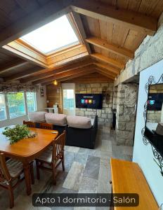 a living room with a table and a fireplace at La Consentida in La Cabrera