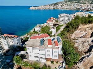 an aerial view of a building next to the water at Unico ApartHotel in Sarandë