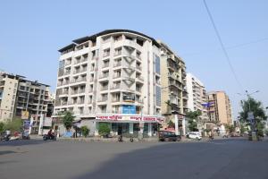 a large white building on a city street at FabHotel Aqua Pearl Inn in Navi Mumbai +18 photos