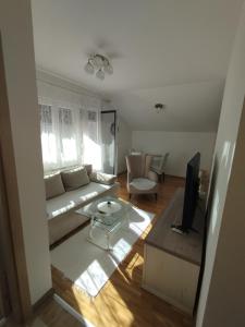 a living room with a couch and a table at DežaVu in Ledine