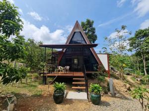 a house with a thatched roof at Echo Falls Khanom in Ban Nua Tha