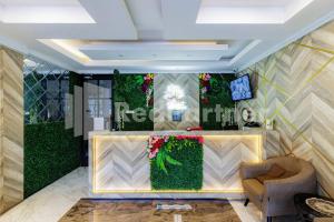 a lobby of a hotel with a flower wall at Tree Homestay Mitra RedDoorz in Kasri