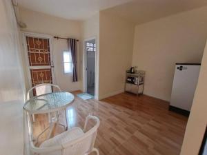 an empty living room with a table and chairs at Kasalong stay in Ban Nong Chaeng
