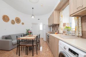 a kitchen and living room with a table and chairs at The Stone Nest in Kefalos