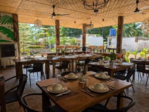 a dining room with wooden tables and chairs at Severina Lodge in San Juan