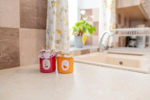 two jars sitting on a counter in a kitchen at The Stone Nest in Kefalos +22 photos