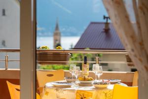 a table with glasses and food on top of a balcony at Radonjić Apartments in Kotor
