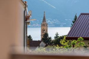 a church steeple with a clock tower in the distance at Radonjić Apartments in Kotor