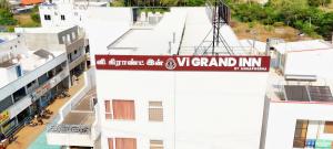 a street sign on the side of a building at Vi Grand inn in Satyamangalam