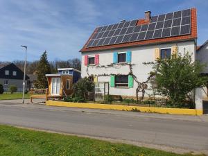 a house with solar panels on the roof at Tinyhouse Rhön-Saale in Wülfershausen