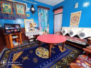 a living room with a table and a couch at Homestay Blue Horizon in Darjeeling