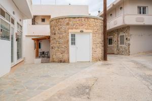 a stone building with a white door on it at The Stone Nest in Kefalos
