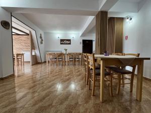 a dining room with a table and chairs at Casa Complex Borsa in Statjunea Borsa +13 photos