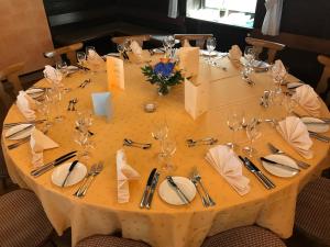 a table with wine glasses and napkins on it at Gasthaus zum Hirsch Hotel - Restaurant in Weier
