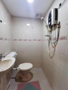 a bathroom with a toilet and a sink at My Seven Day Inn in Masai