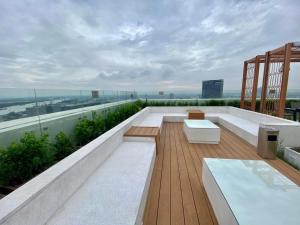 a balcony with benches and tables on a building at BRG Premium Apartments in Hai Phong