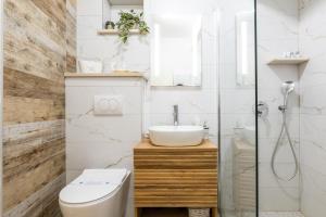 a bathroom with a toilet and a sink and a shower at Apartman Ana Lotre in Vela Luka +21 photos