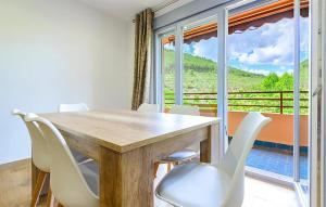 a dining room table with white chairs and a large window at Apto Jérica in Jérica
