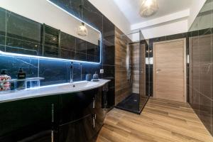 a bathroom with a sink and a shower at Chateau De La Rose in Fonte Nuova +24 photos