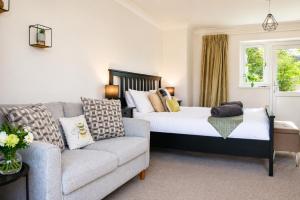 a living room with a bed and a couch at Lytton Tree Lodge Self-Catering Garden Lodges - Near Southwold in Reydon