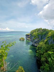 a view of the ocean with rocks in the water at Kampa Lodge in Tano