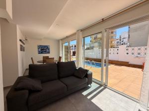 a living room with a couch and a balcony at Agi Las Acacias in Roses