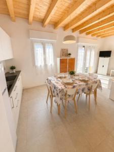 a dining room with a table and chairs in a kitchen at RESIDENCE PACE - Agenzia Cocal in Caorle