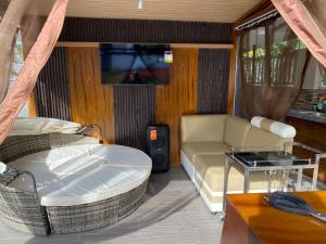 a living room with a couch and a table at Casa Sandrine Resort in Malolos