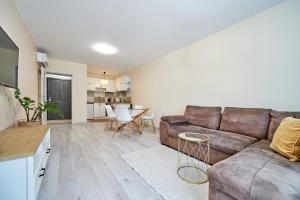 a living room with a couch and a table at 100m from the BEACH! ALDEA complex with pool in Kavarna